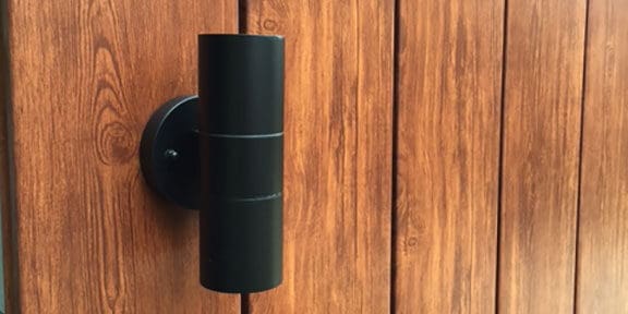 close up view of timber-look wall cladding with light fixture