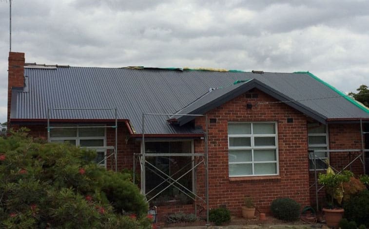 A brick home in Balwyn with steel roof being installed