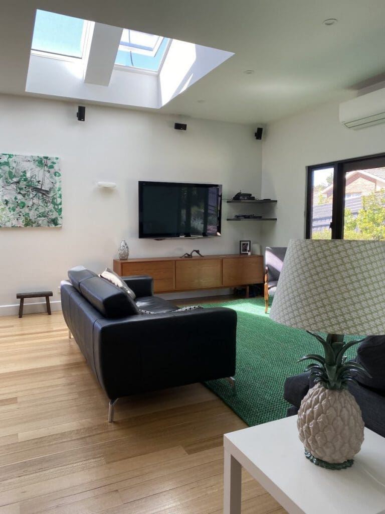 View from beneath skylight shafts illuminating a living room area