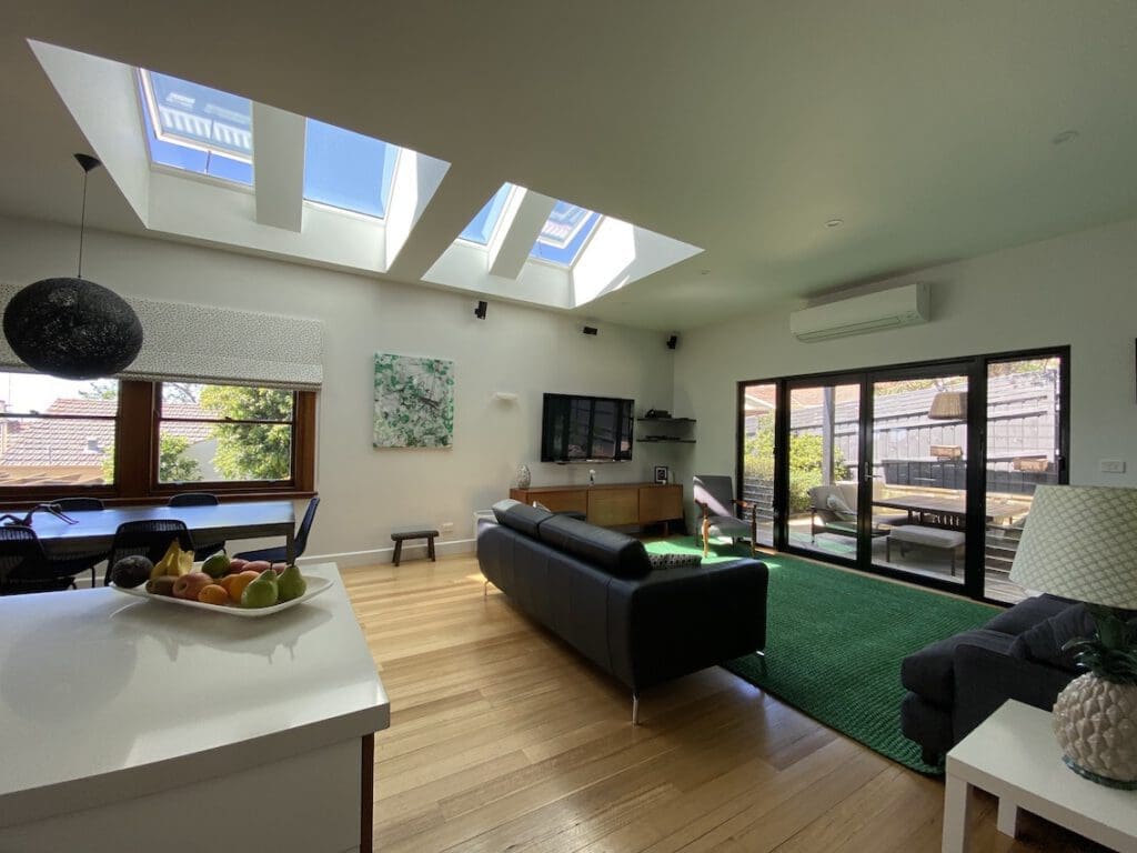 A Rosanna living room illuminated by a bank of 4 skylights
