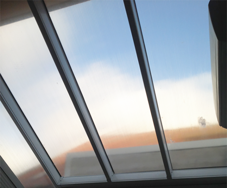 Cloudy blue sky seen through multiwall polycarbonate roof